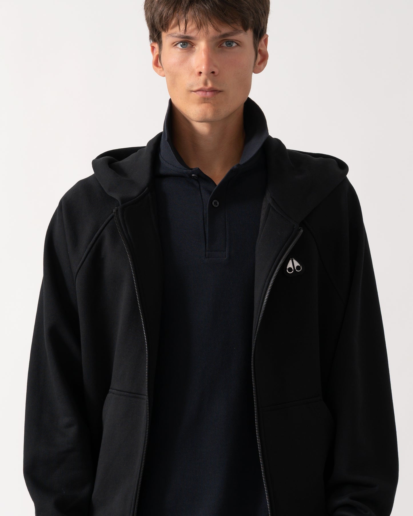 close up of a model wearing a Moose Knuckles Mens Yul Zip Up Hoodie in Black 292