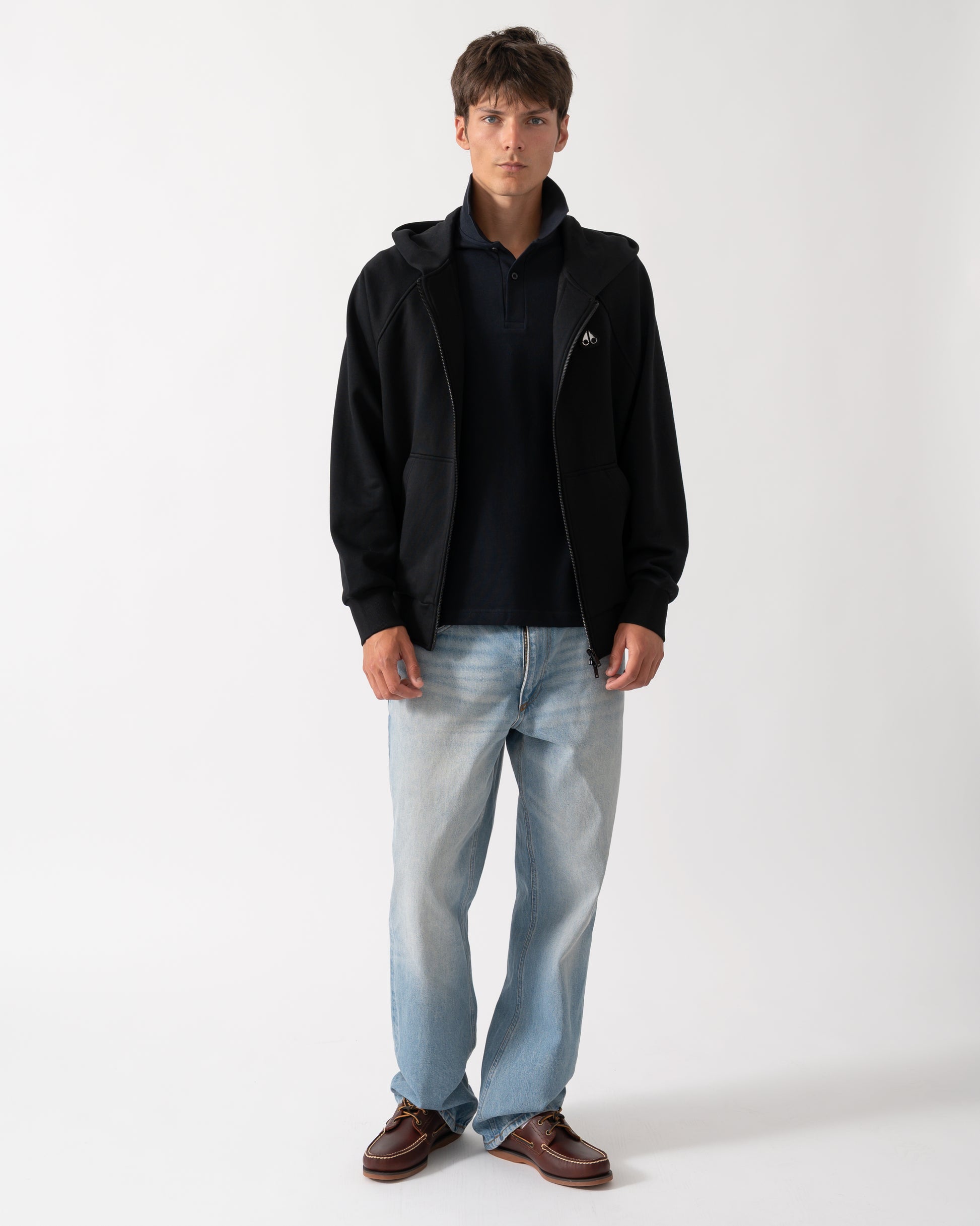 full length of a model wearing a Moose Knuckles Mens Yul Zip Up Hoodie in Black 292