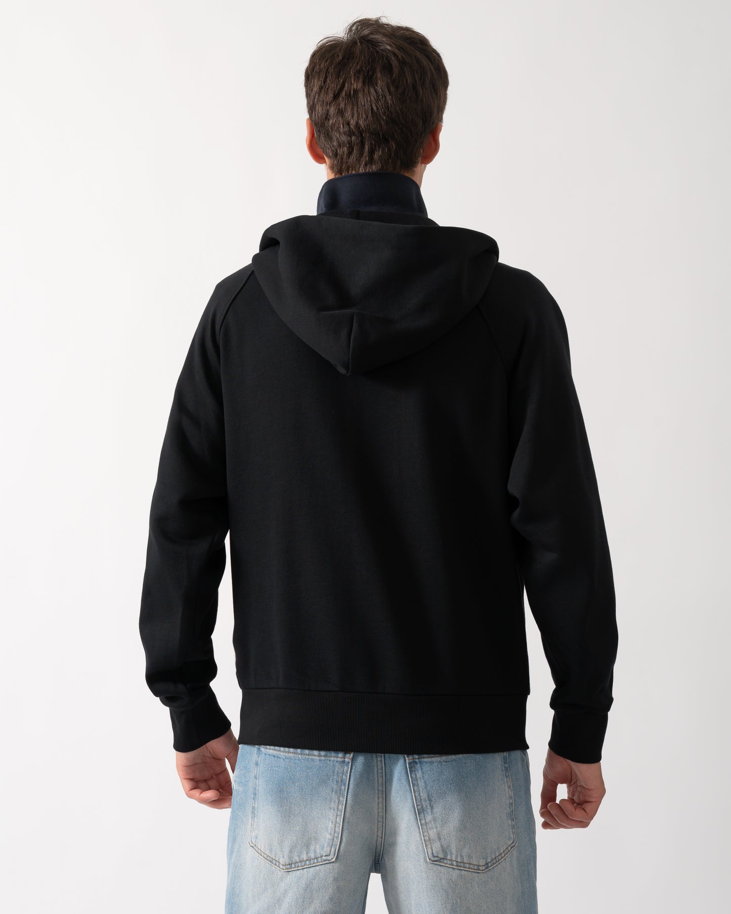 back of a a model wearing a Moose Knuckles Mens Yul Zip Up Hoodie in Black 292