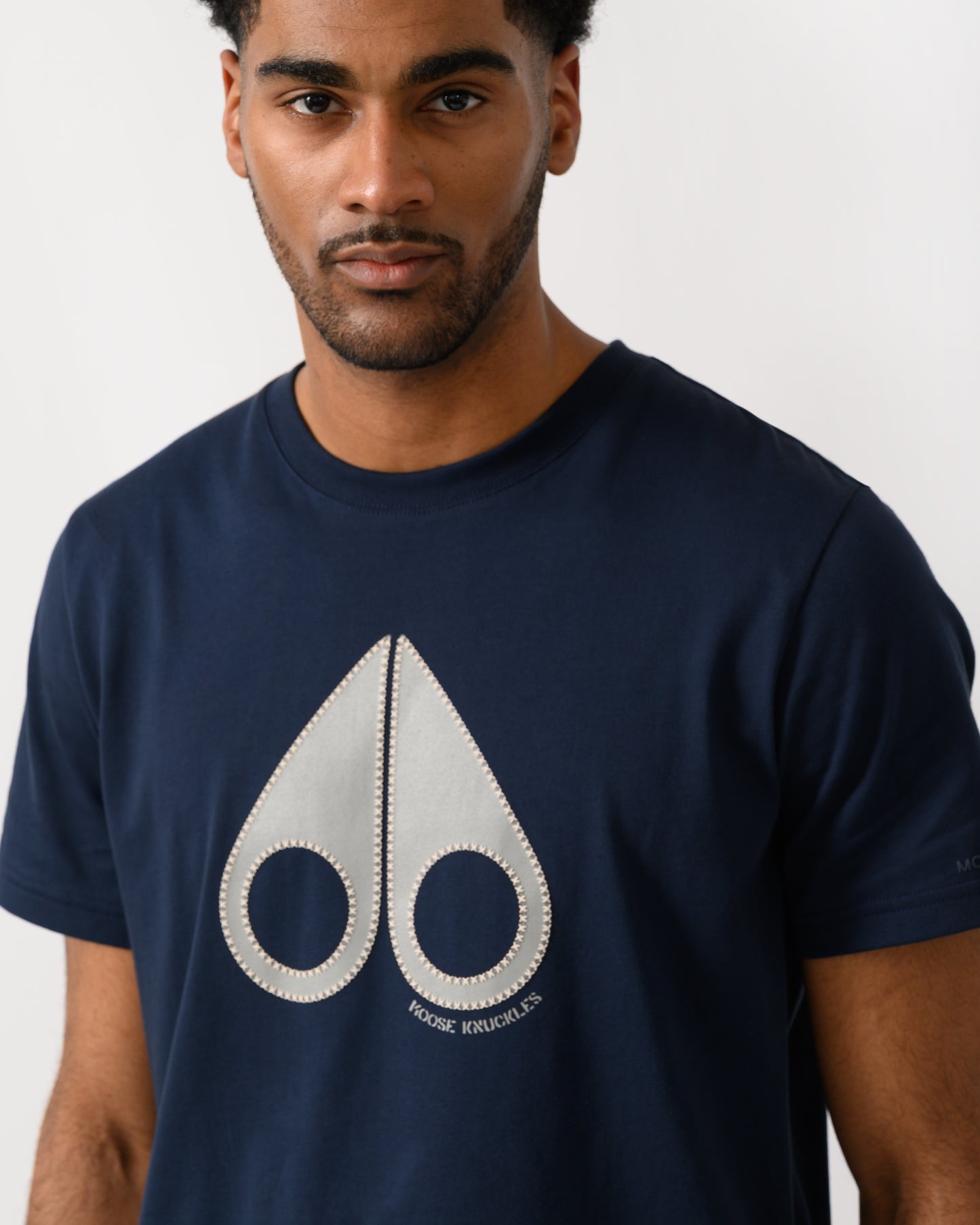 close up shot of a model wearing a Moose Knuckles Tandem Mens T-Shirt in Navy 833