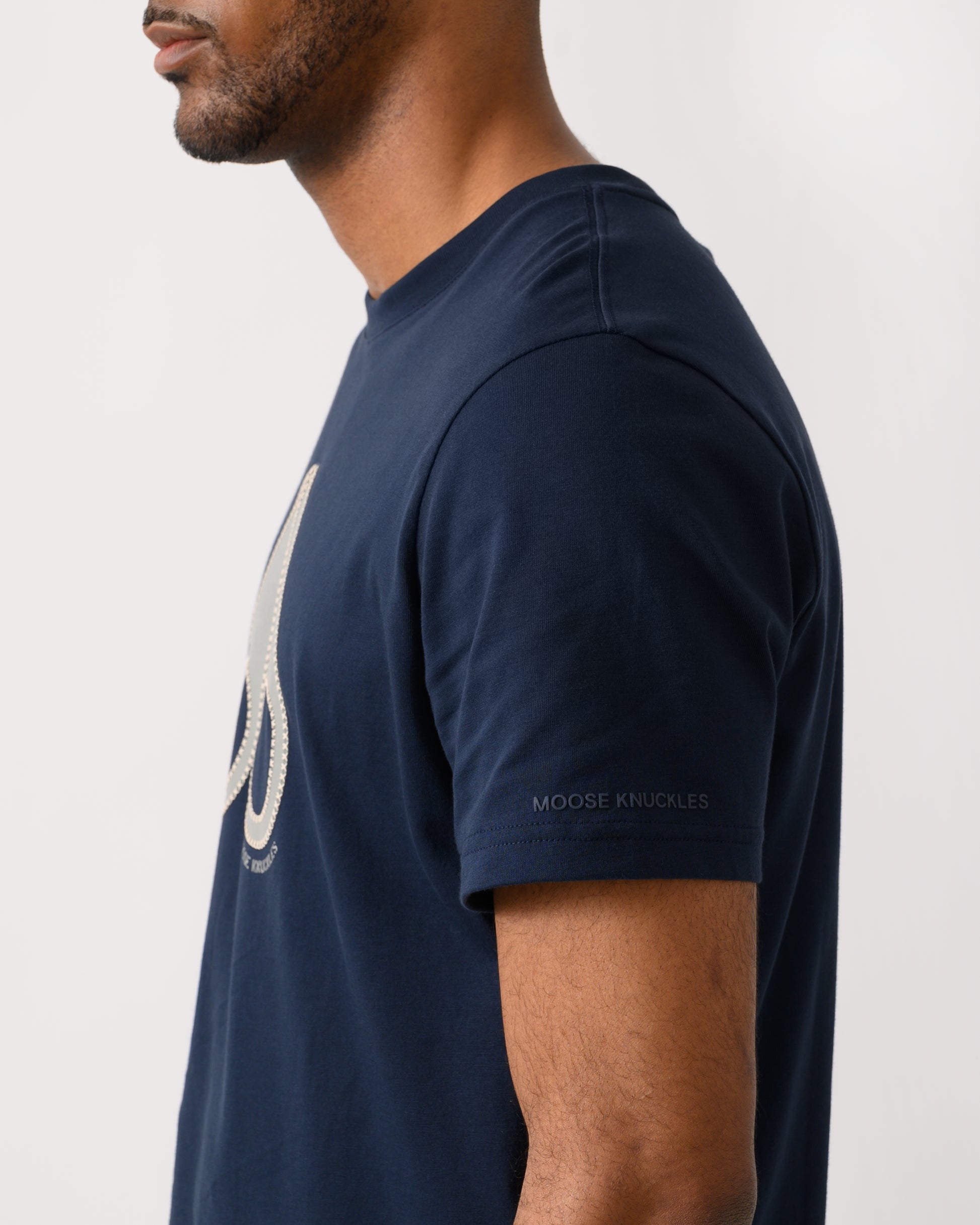 back shot of a model wearing a Moose Knuckles Tandem Mens T-Shirt in Navy 833