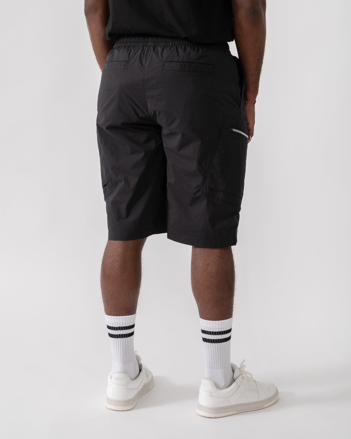 Model wearing Moose Knuckles Topflight Mens Cargo Shorts in Black 292 - back