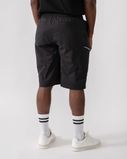 Model wearing Moose Knuckles Topflight Mens Cargo Shorts in Black 292 - back