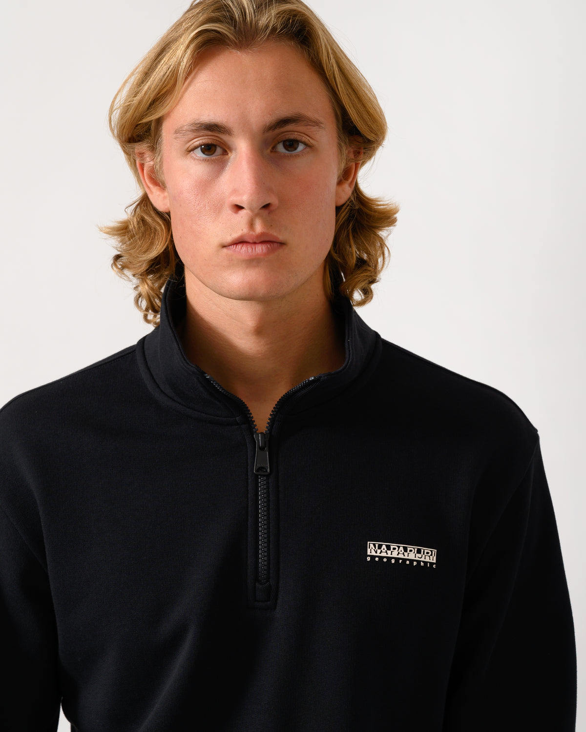 close up studio photograph of a model wearing a Napapijri Small Box Mens Half Zip Sweatshirt in Black Beauty 941