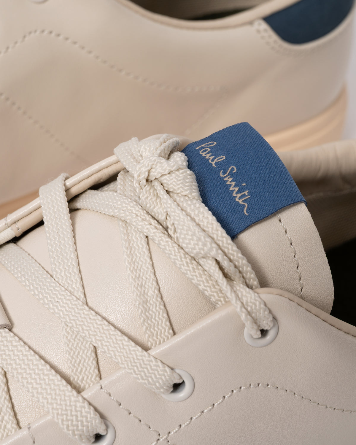 Studio photograph showing close up of PS Paul Smith Chip Leather Mens Trainers in 01 White