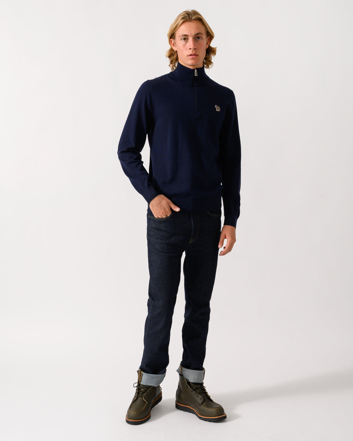 full length studio photograph of a model wearing a PS Paul Smith Mens 1/4 Zip Zebra Badge Sweater in 49 Very Dark Navy