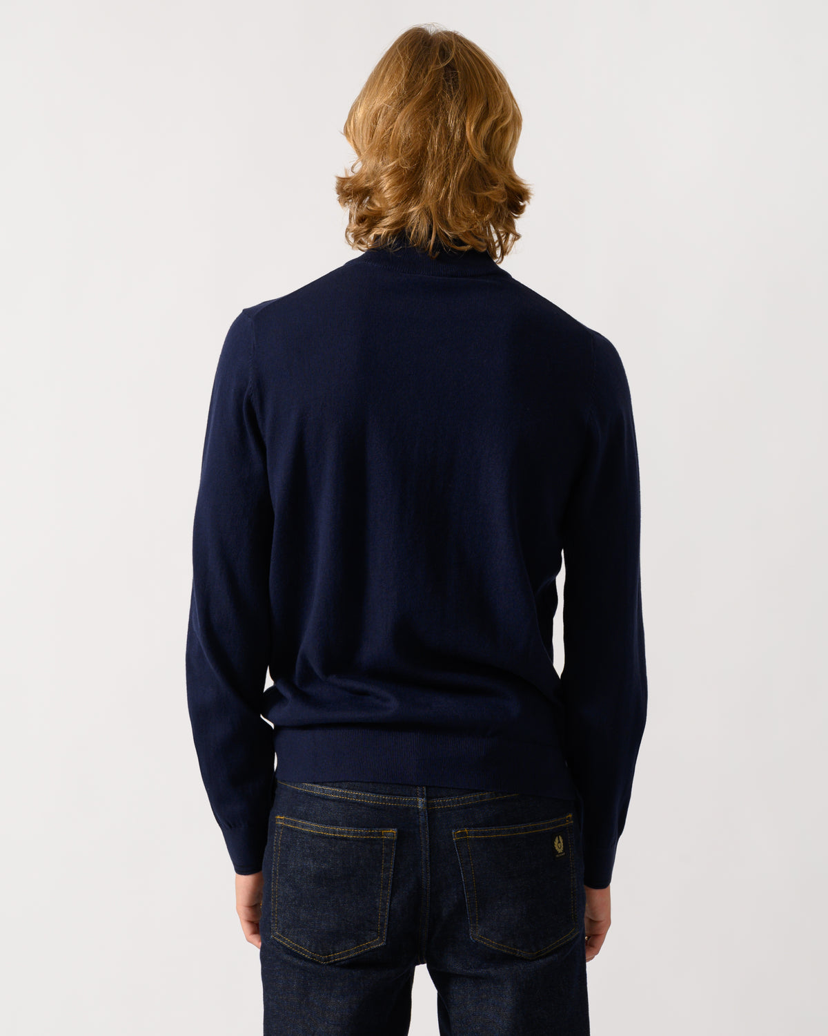 studio photograph showing back of a model wearing a PS Paul Smith Mens 1/4 Zip Zebra Badge Sweater in 49 Very Dark Navy