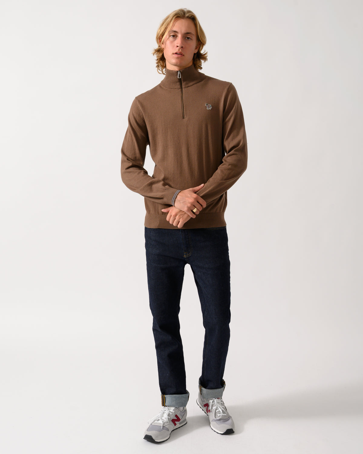 full length of a model wearing a PS Paul Smith Mens 1/4 Zip Zebra Badge Sweater in 67 Mud