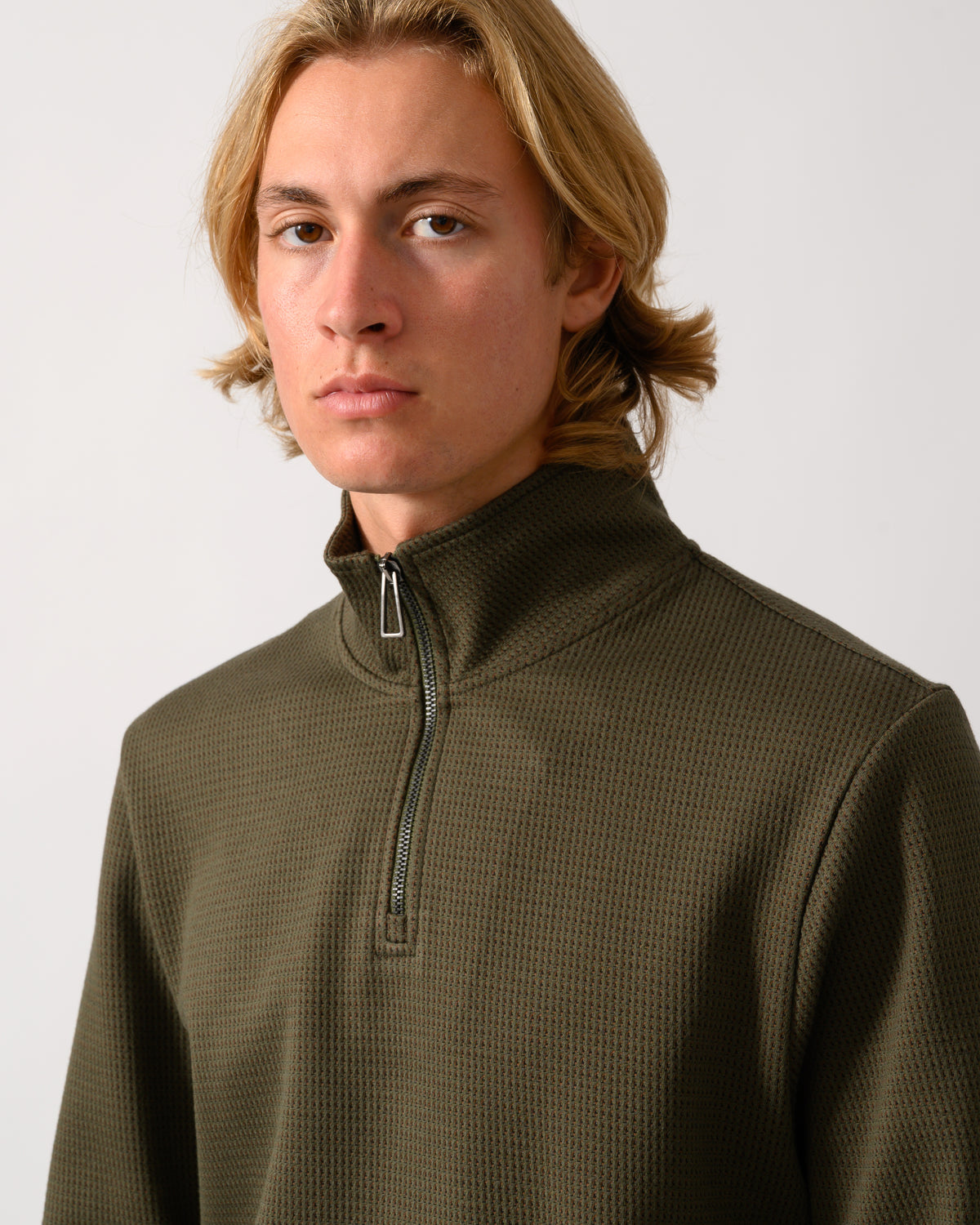 close up of model wearing a PS Paul Smith Mens Classic Half Zip Top in 35 Military Green
