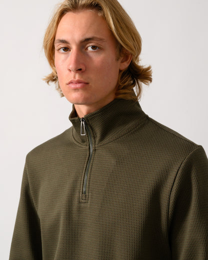 close up of model wearing a PS Paul Smith Mens Classic Half Zip Top in 35 Military Green