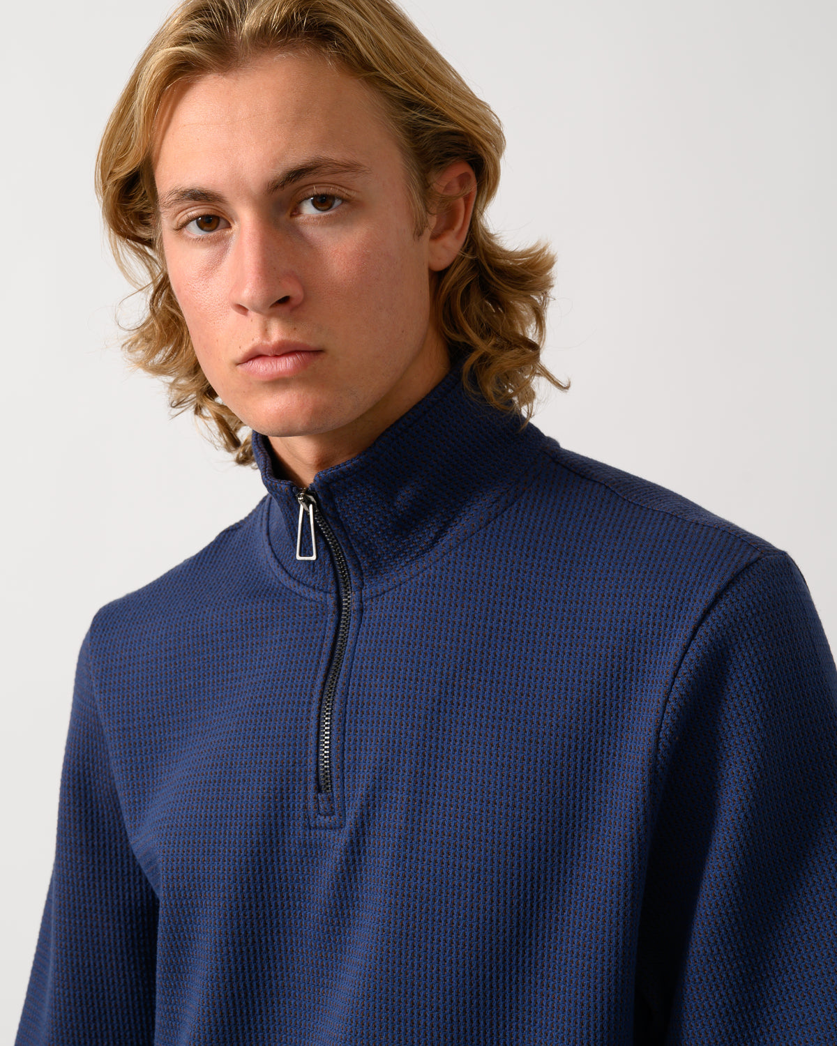 close up studio portrait of a model wearing a PS Paul Smith Mens Classic Half Zip Top in 46 Indigo