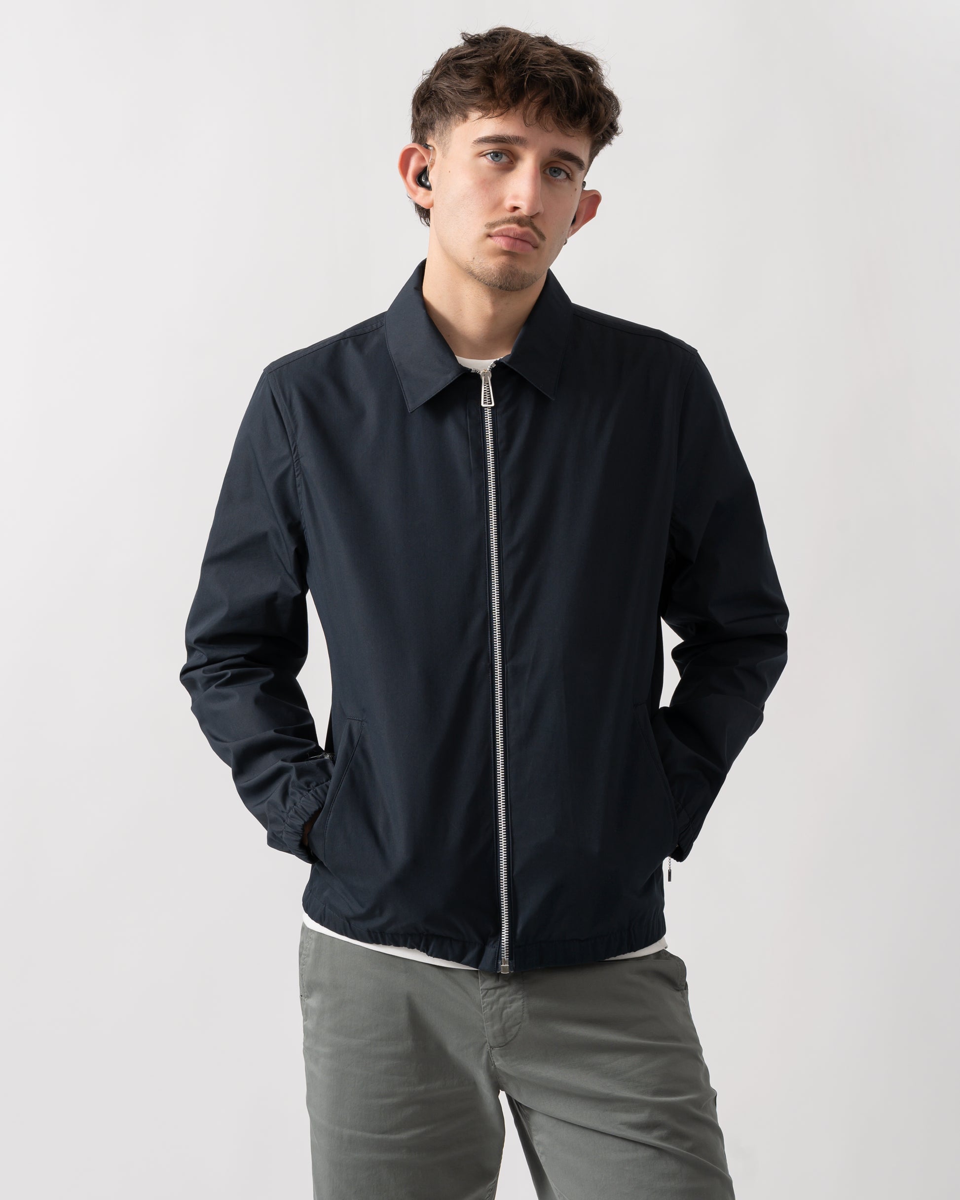 studio shot of a model wearing a PS Paul Smith Mens Coach Jacket in 49 Very Dark Navy