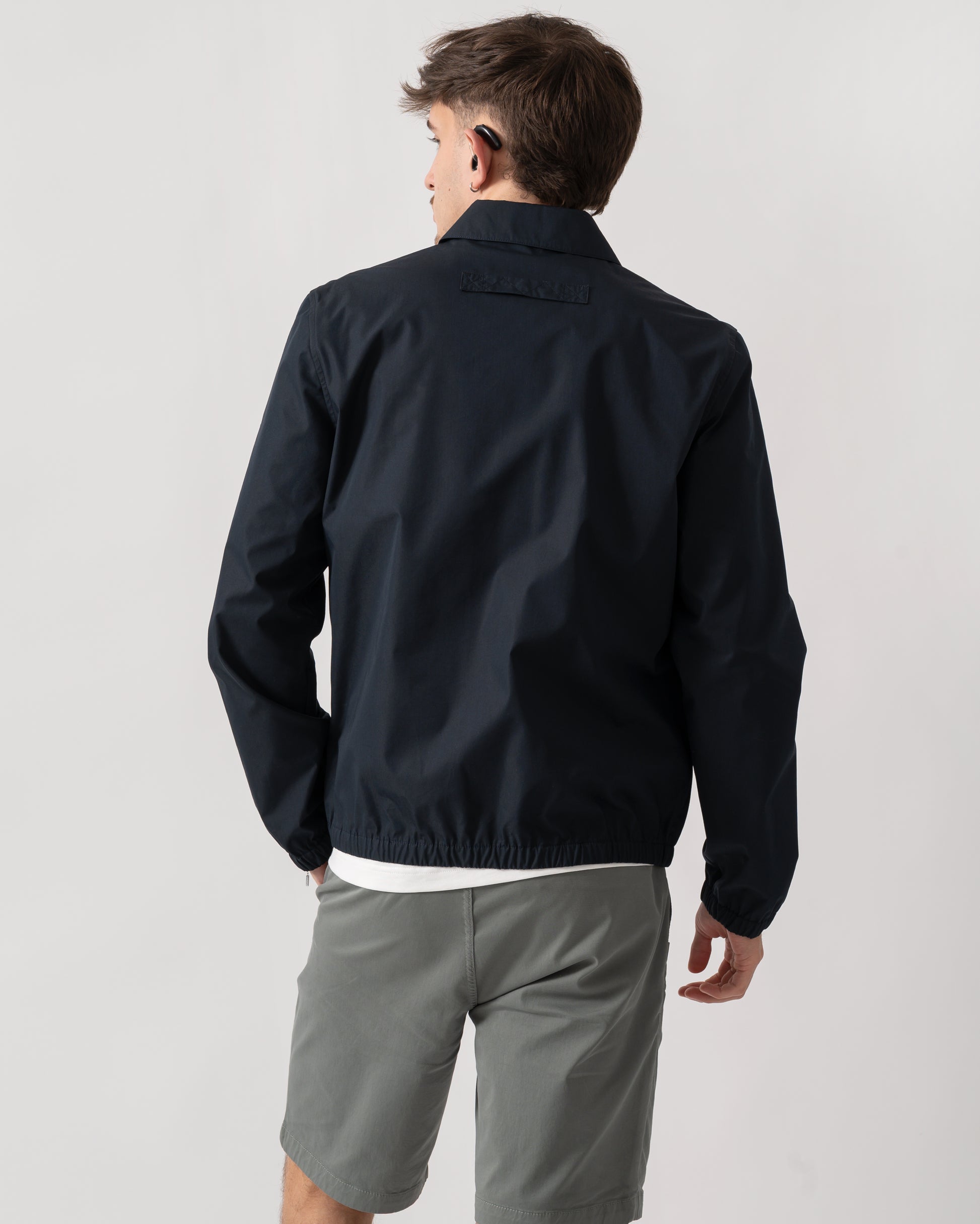 back shot of a model wearing a PS Paul Smith Mens Coach Jacket in 49 Very Dark Navy
