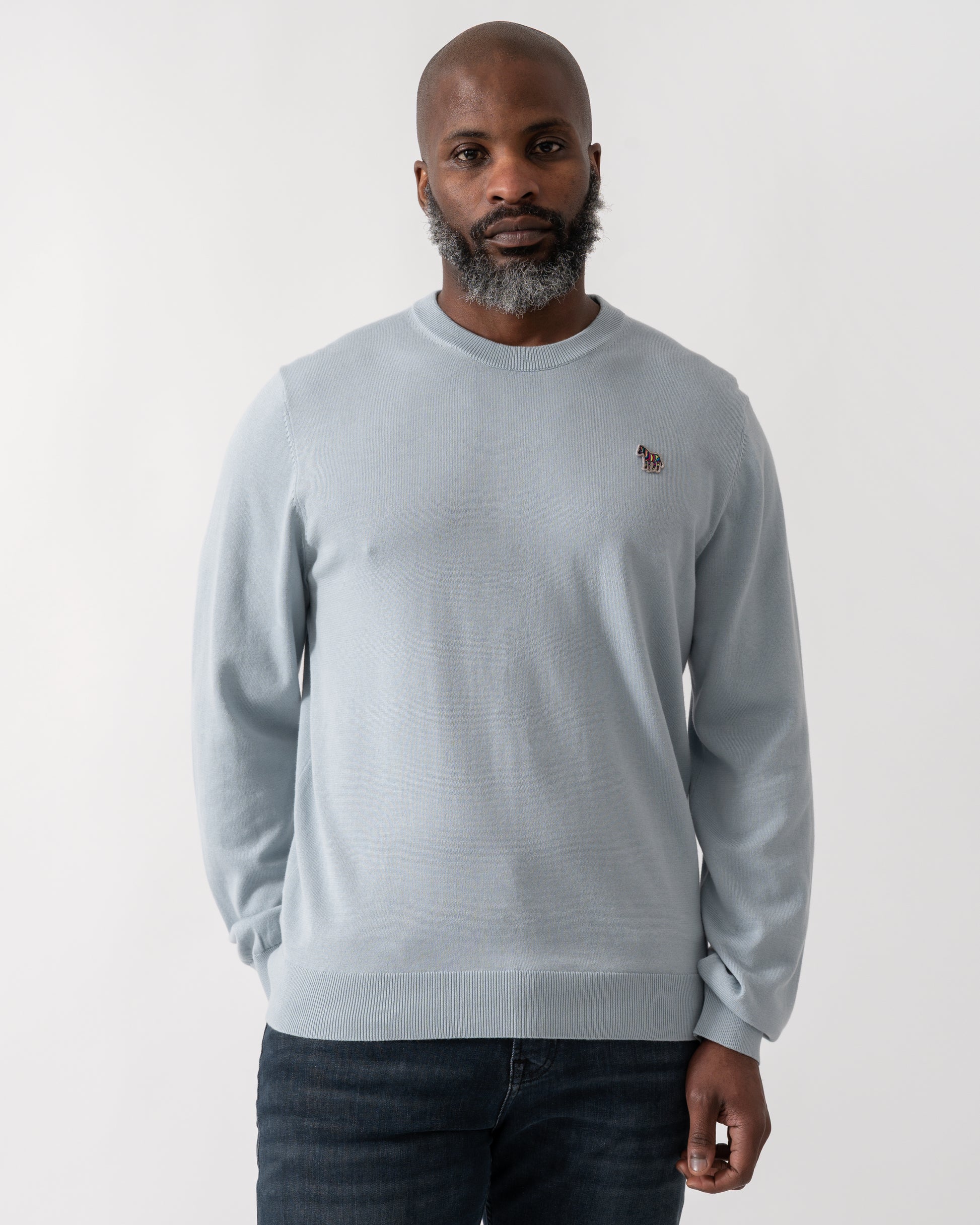 Model wearing a PS Paul Smith Mens Crew Neck Zebra Badge Jumper in Blue