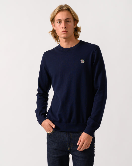 studio photograph of a model wearing a PS Paul Smith Mens Crew Neck Zebra Badge Sweater in 49 Very Dark Navy