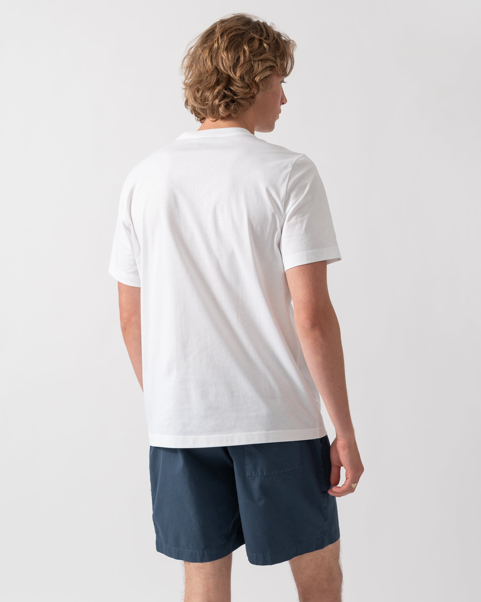 back shot of a model wearing a PS Paul Smith Mens Football Graphic T-Shirt in 01 White
