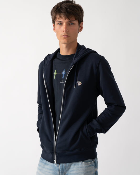 a model wearing a PS Paul Smith Mens Full Zip Hoodie with Zebra Logo in 49 Very Dark Navy