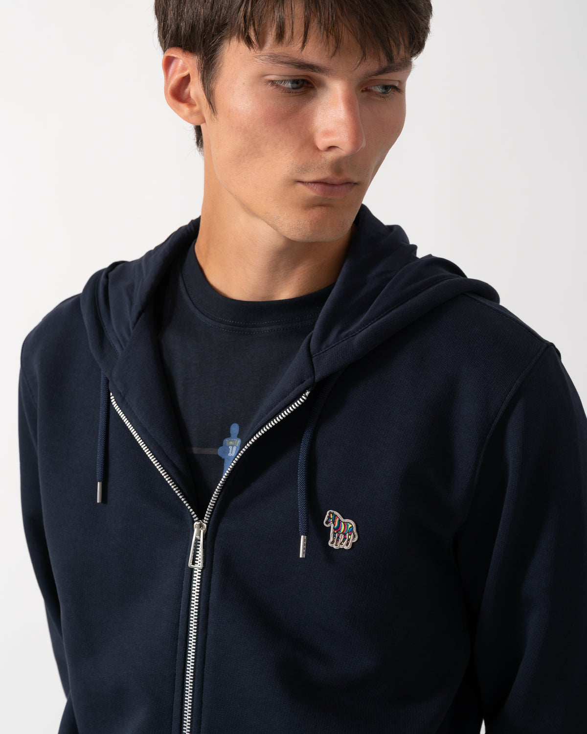 close up of a model wearing a PS Paul Smith Mens Full Zip Hoodie with Zebra Logo in 49 Very Dark Navy