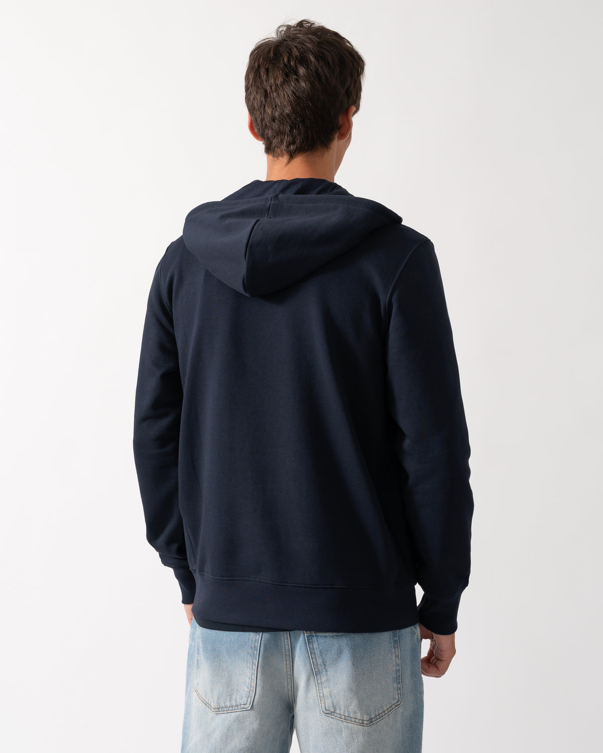 back of  a model wearing a PS Paul Smith Mens Full Zip Hoodie with Zebra Logo in 49 Very Dark Navy