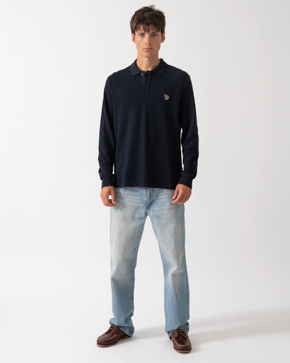 full length of a model wearing a PS Paul Smith Mens Long Sleeve Plain Polo Shirt with Zebra Logo in 49 Very Dark Navy