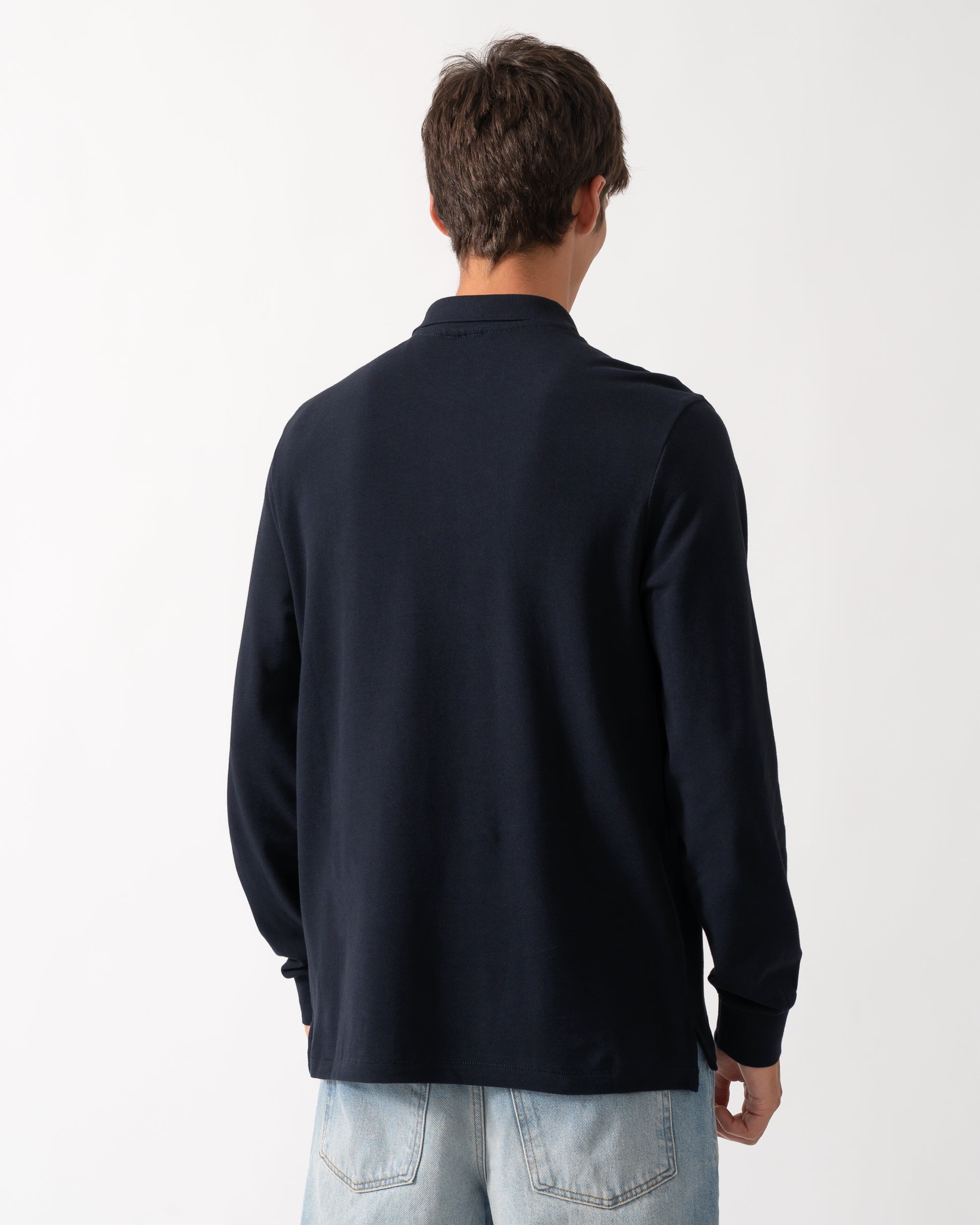 back of a model wearing a PS Paul Smith Mens Long Sleeve Plain Polo Shirt with Zebra Logo in 49 Very Dark Navy