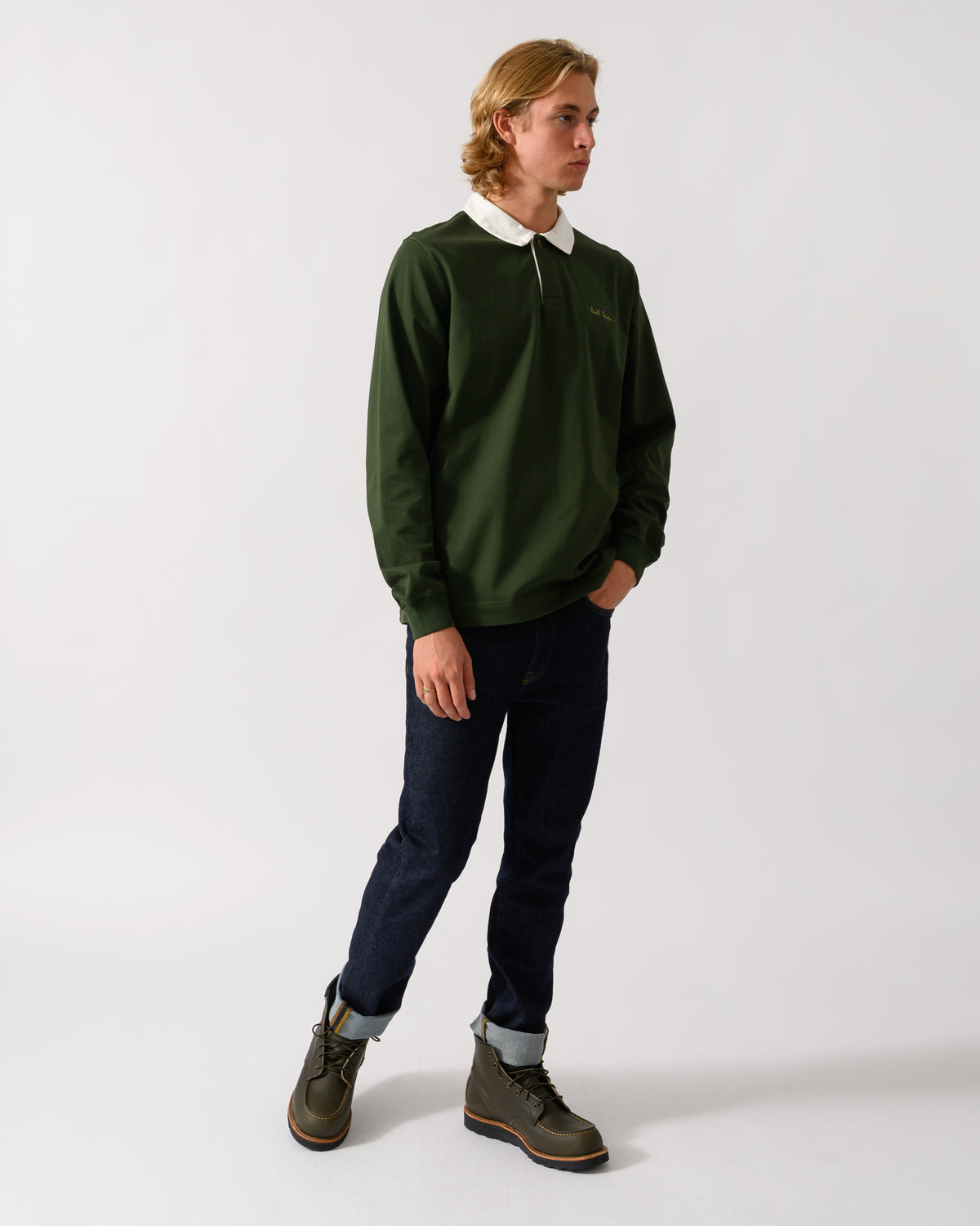 full length studio photograph of a model wearing a PS Paul Smith Mens Long Sleeve Signature Logo Polo in 38A Bottle Green