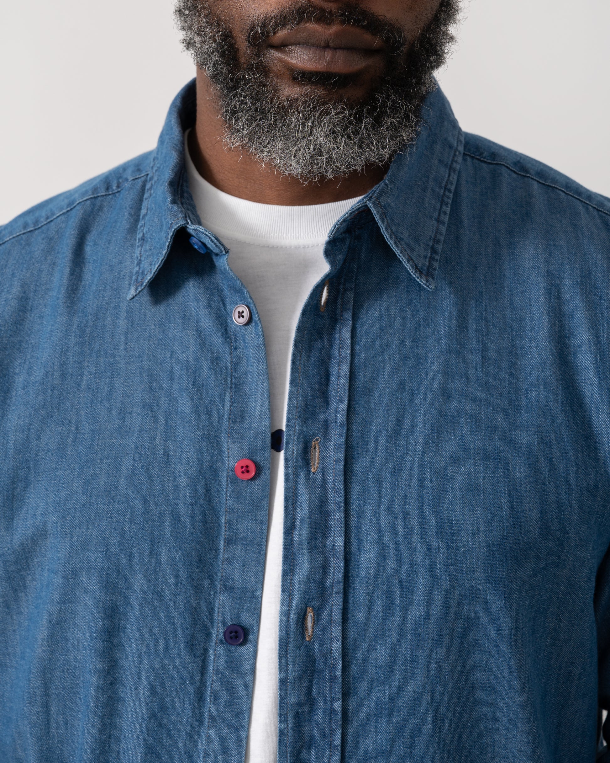 detail shot of a Model wearing a PS Paul Smith Mens Long Sleeve Tailored Fit Denim Shirt SS Buttons in MD Blue