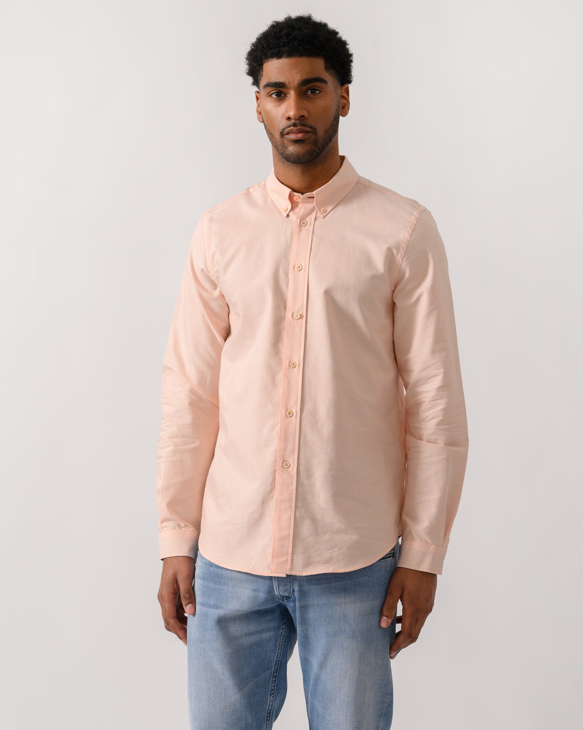 model wearing a PS Paul Smith Mens Long Sleeve Tailored Fit Shirt With Button Down Collar in Orange