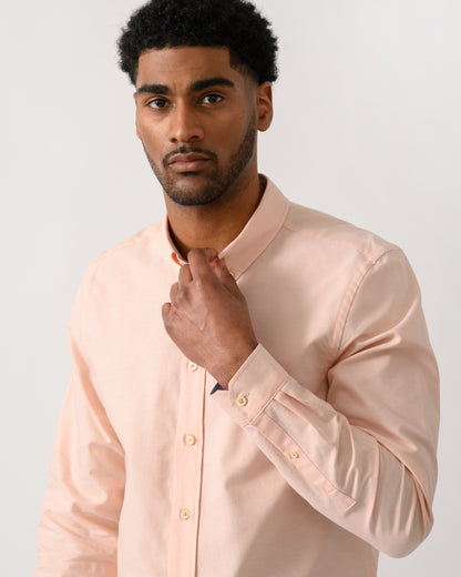 close up shot of a model wearing a PS Paul Smith Mens Long Sleeve Tailored Fit Shirt With Button Down Collar in Orange