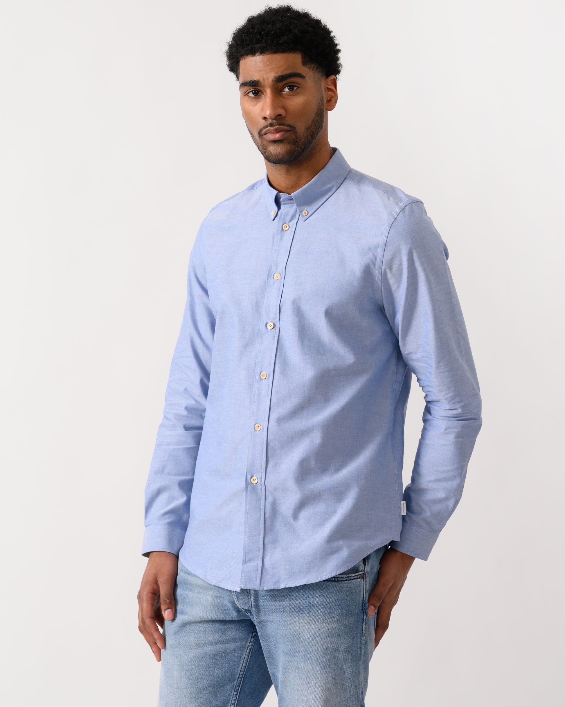 model wearing a PS Paul Smith Mens Long Sleeve Tailored Fit Shirt With Button Down Collar in 44 Blue