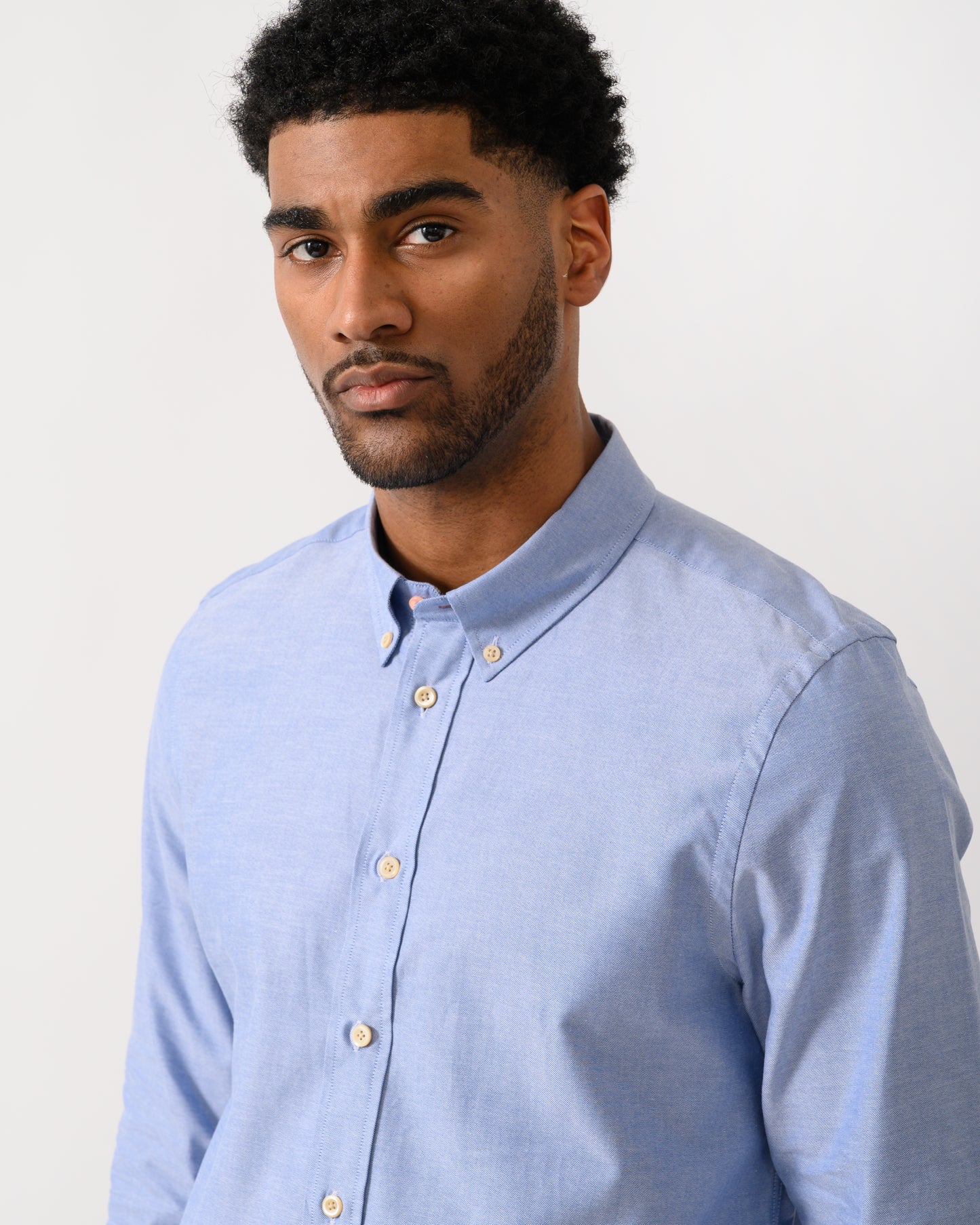 close up shot of a model wearing a PS Paul Smith Mens Long Sleeve Tailored Fit Shirt With Button Down Collar in 44 Blue