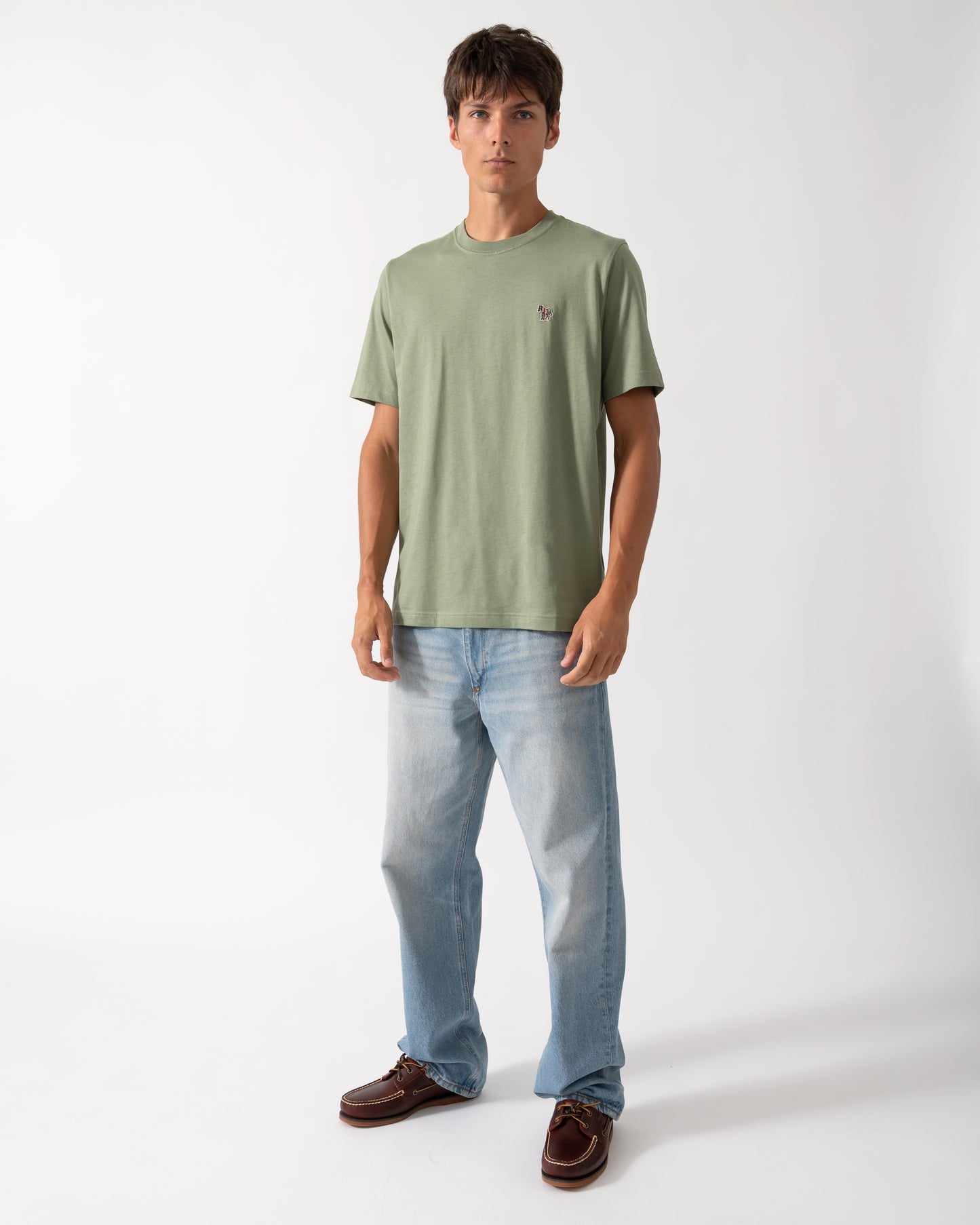 full length of a model wearing a PS Paul Smith Mens Organic Cotton Zebra Logo T-Shirt in 34D Light Greyish Green