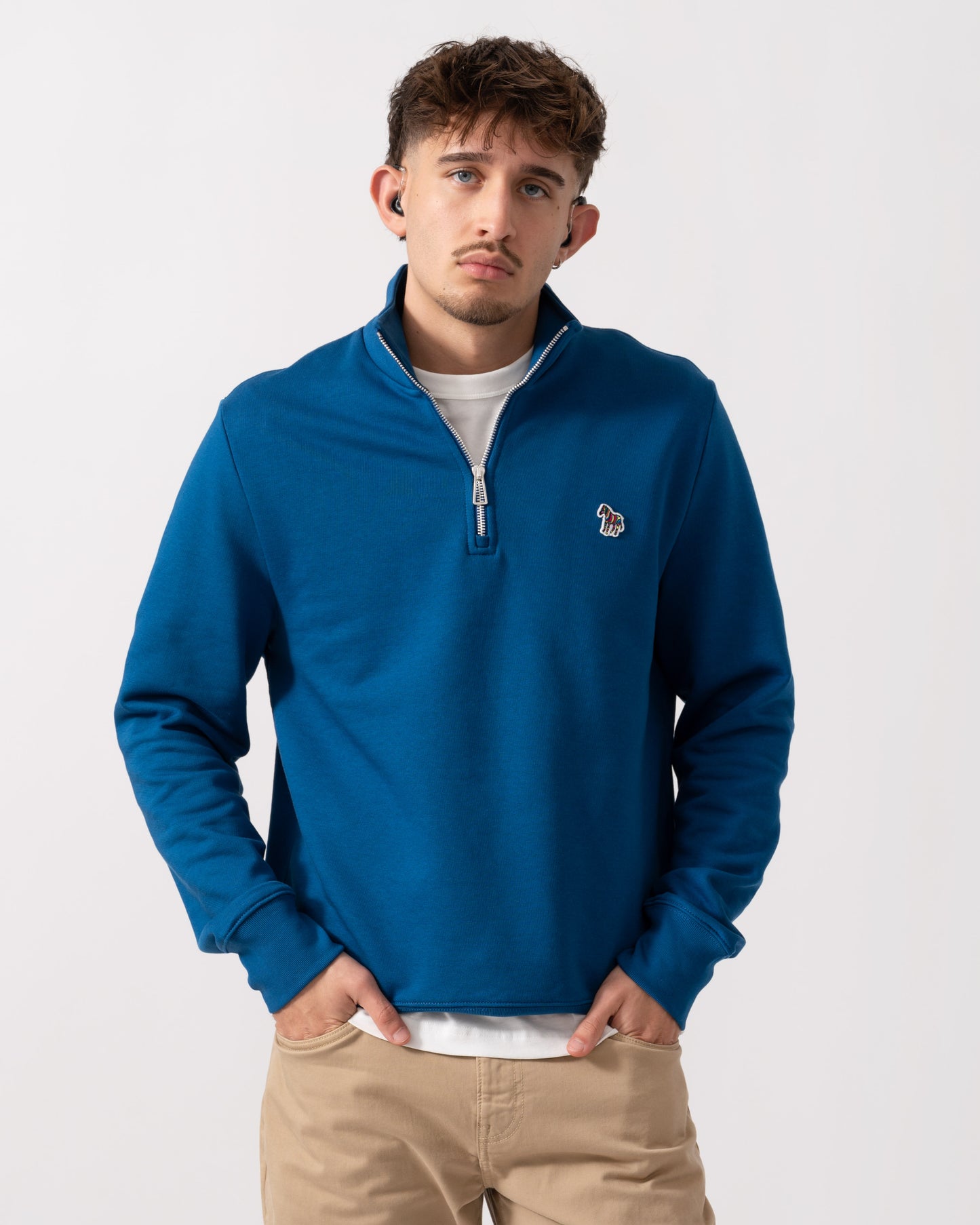 Model wearing a PS Paul Smith Mens Reg Fit Half Zip Zebra Logo Top in Blue