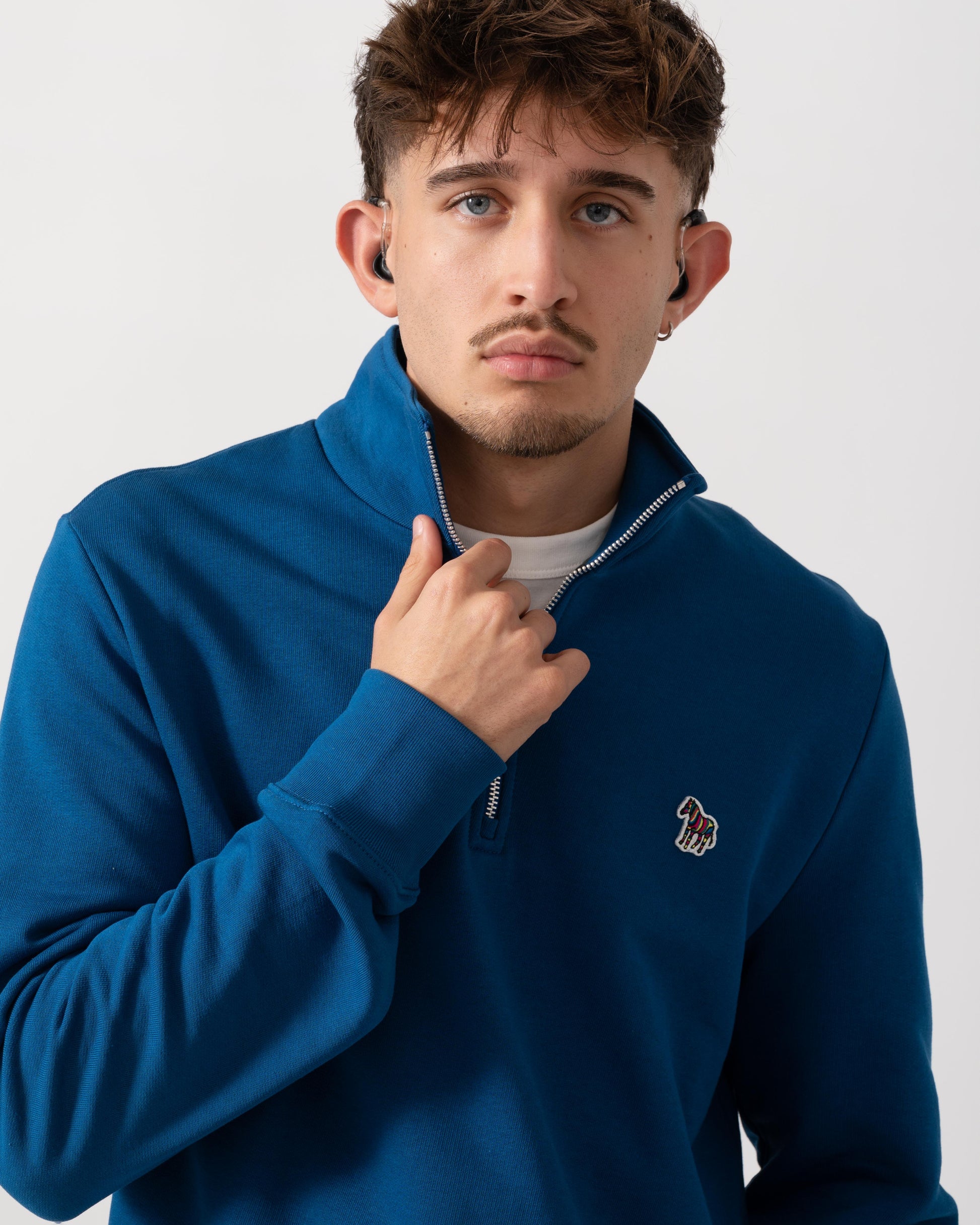 detail shot of a Model wearing a PS Paul Smith Mens Reg Fit Half Zip Zebra Logo Top in Blue