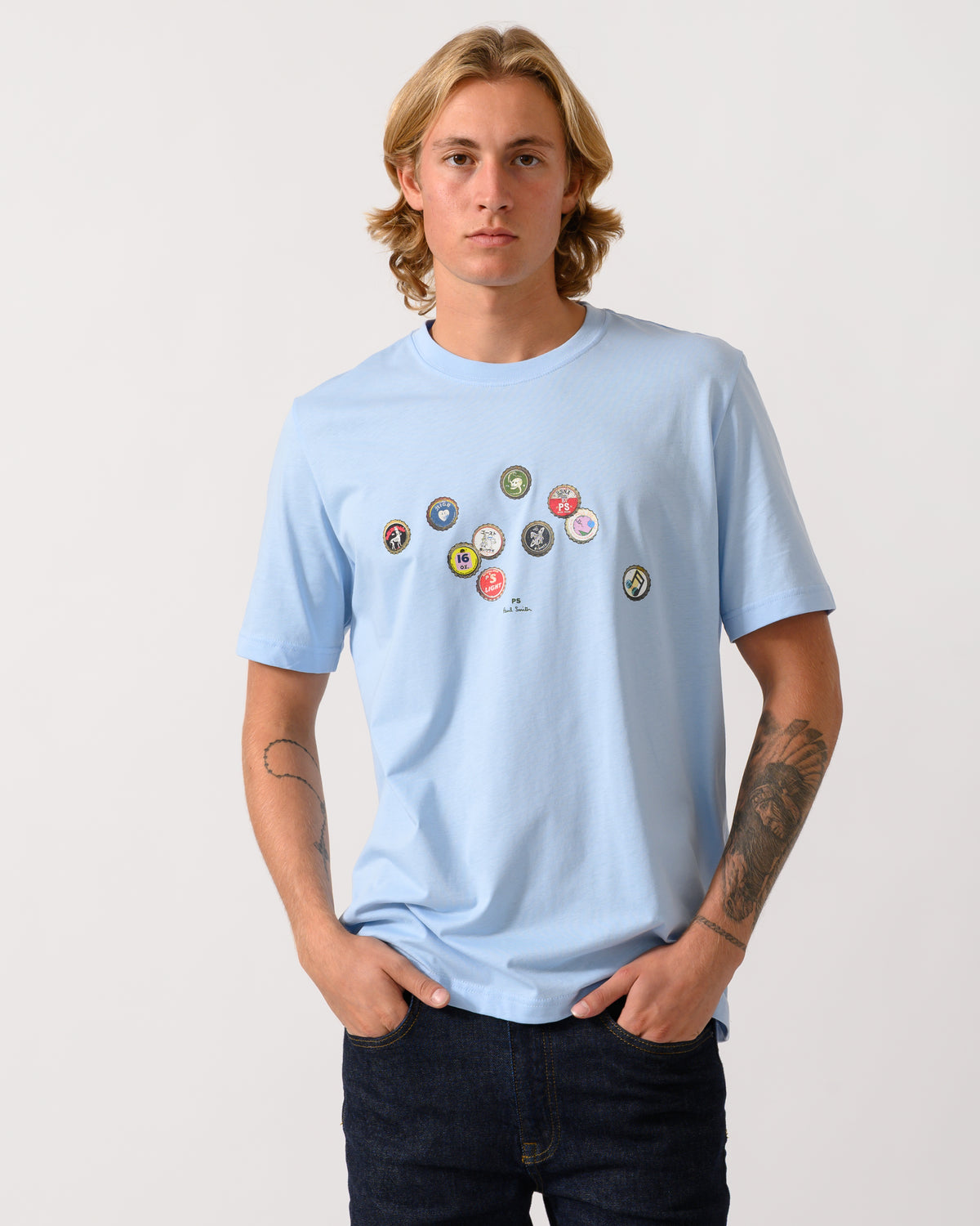 studio photograph of a model wearing a PS Paul Smith Mens Regular Fit Bottle Tops Graphic T-Shirt in 41E Light Blue