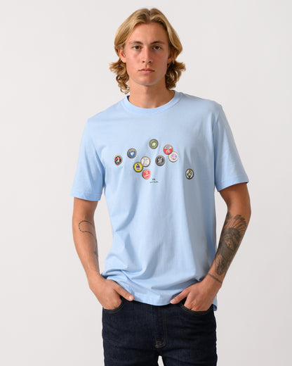 studio photograph of a model wearing a PS Paul Smith Mens Regular Fit Bottle Tops Graphic T-Shirt in 41E Light Blue