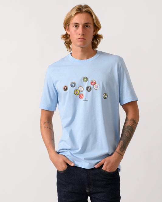 studio photograph of a model wearing a PS Paul Smith Mens Regular Fit Bottle Tops Graphic T-Shirt in 41E Light Blue