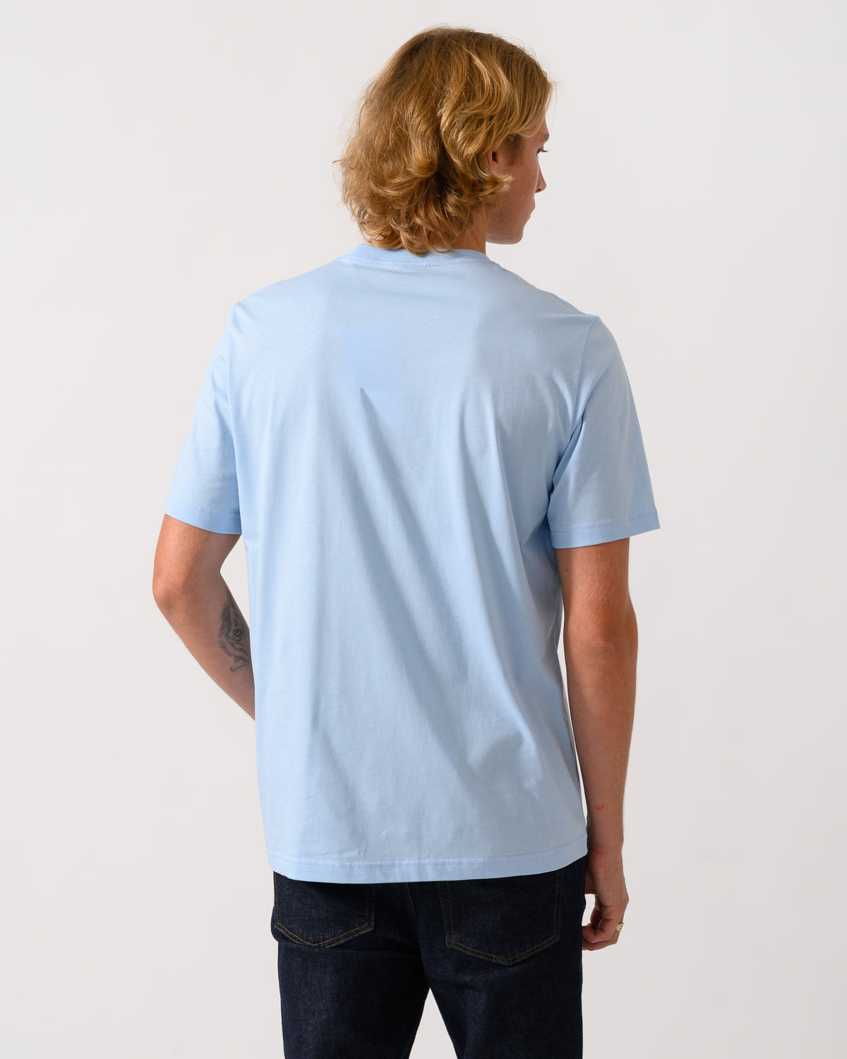 studio photograph showing back of a model wearing a PS Paul Smith Mens Regular Fit Bottle Tops Graphic T-Shirt in 41E Light Blue