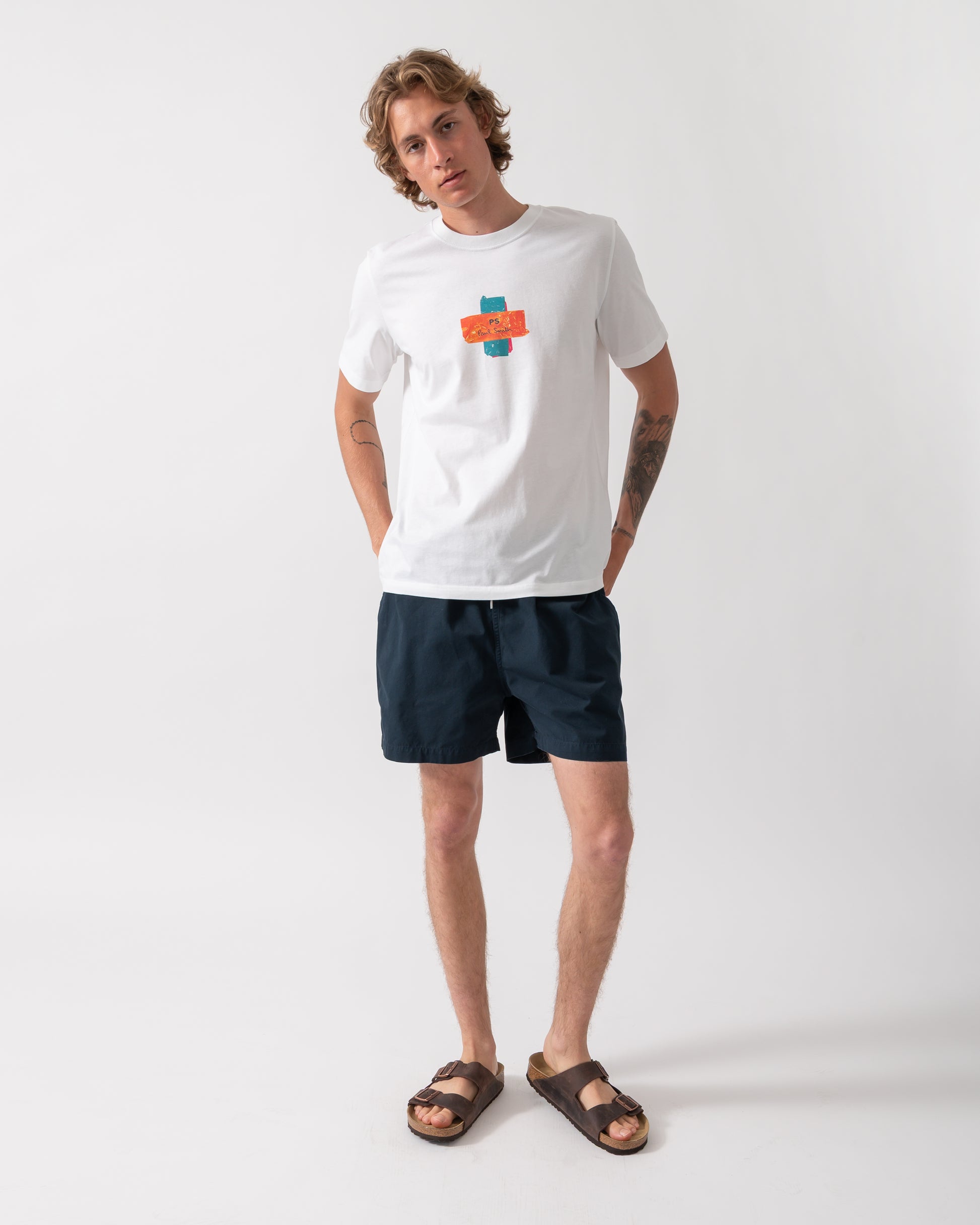 full length of model wearing a PS Paul Smith Mens Regular Fit Cross T-Shirt in 01 White