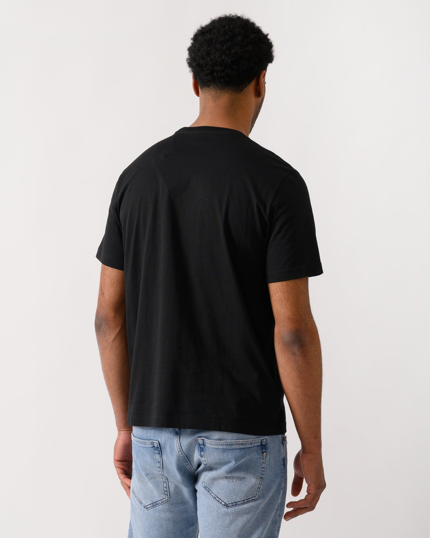 back shot of a model wearing a PS Paul Smith Mens Regular Fit Cross T-Shirt in 79 Black