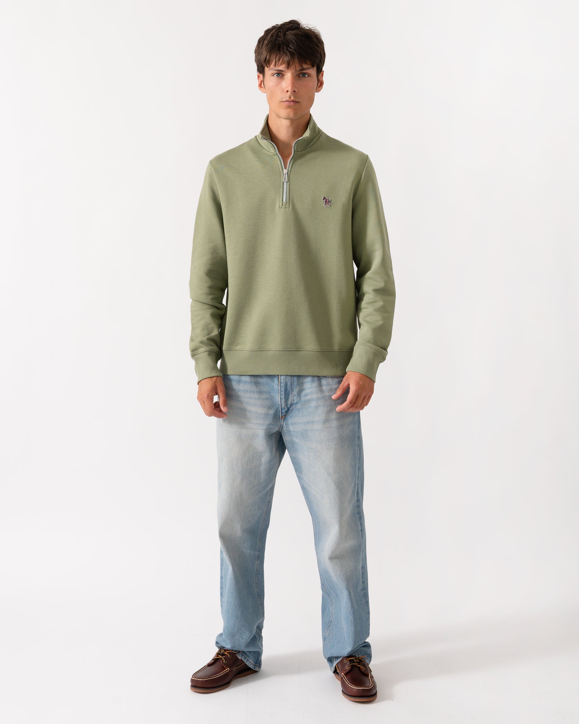 full length of a model wearing a PS Paul Smith Mens Regular Fit Half Zip Sweatshirt with Zebra Logo in 34C Light Greyish Green