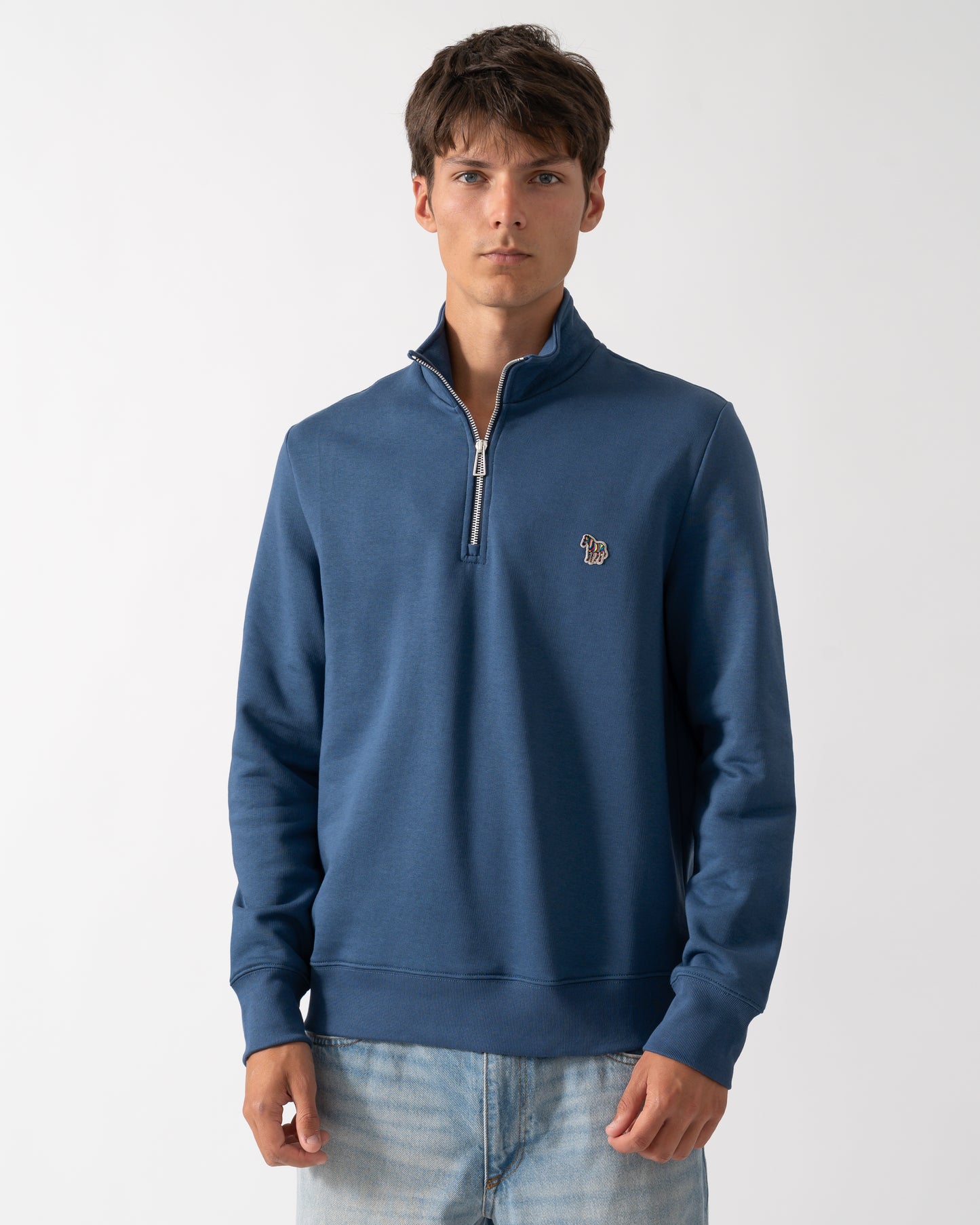 a model wearing a PS Paul Smith Mens Regular Fit Half Zip Sweatshirt with Zebra Logo in 46D Indigo