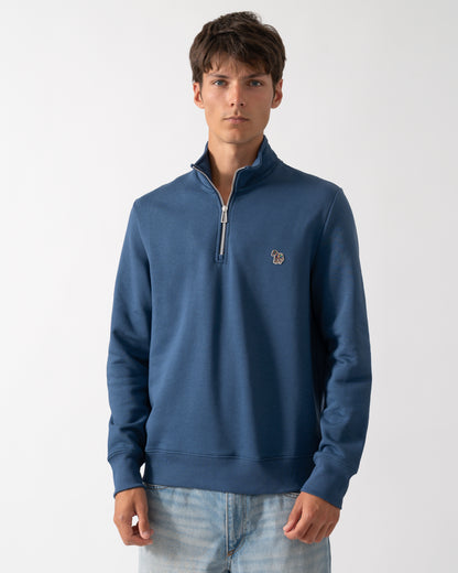 a model wearing a PS Paul Smith Mens Regular Fit Half Zip Sweatshirt with Zebra Logo in 46D Indigo