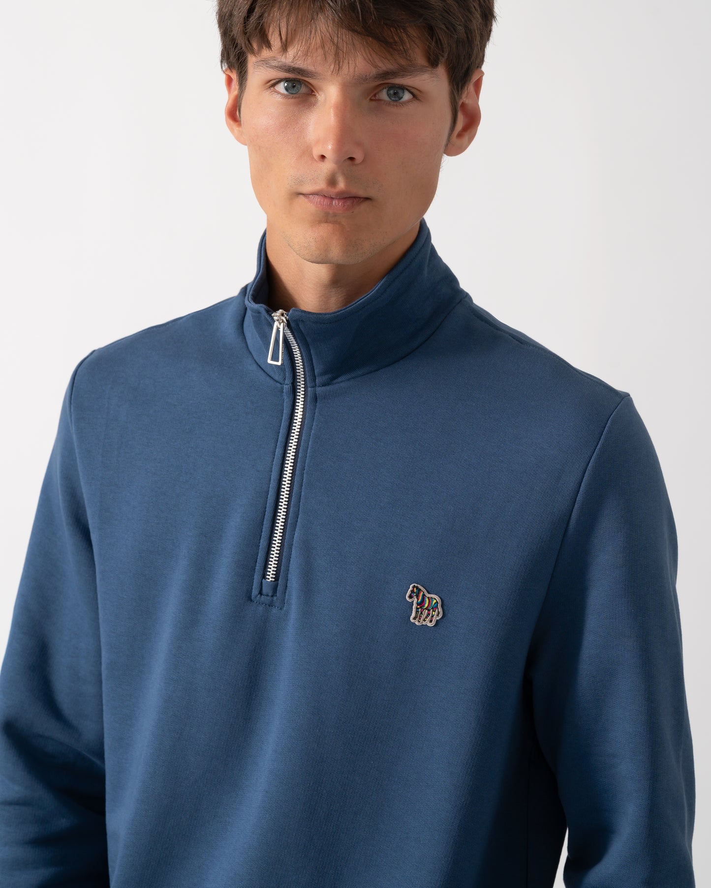 close up of a model wearing a PS Paul Smith Mens Regular Fit Half Zip Sweatshirt with Zebra Logo in 46D Indigo
