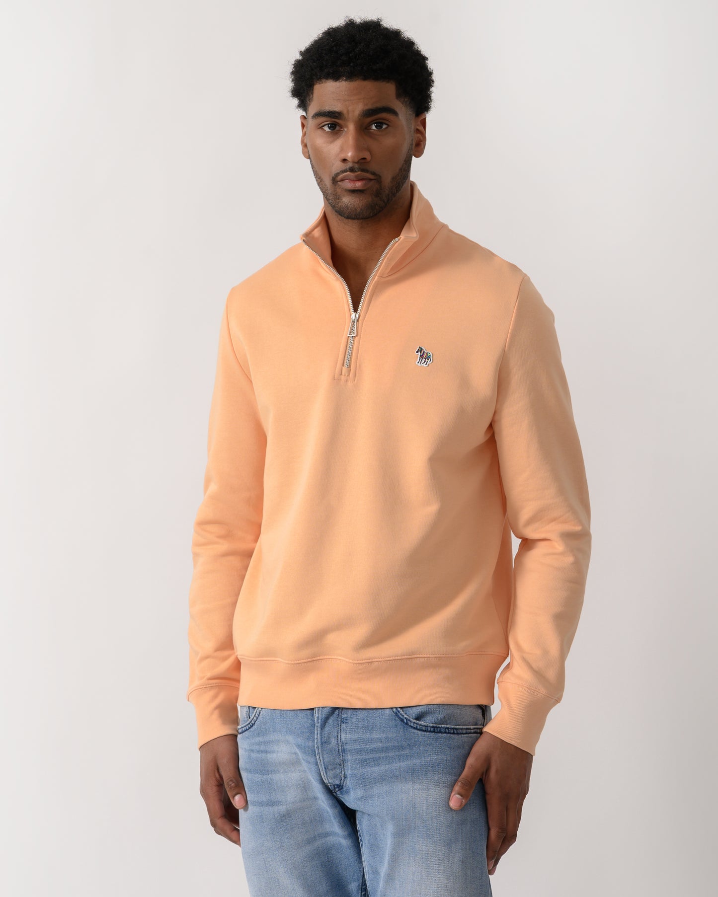 model wearing a PS Paul Smith Mens Regular Fit Half Zip Zebra Logo Top in 15D Orange