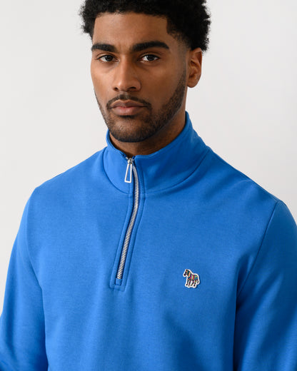 close up shot of a model wearing a PS Paul Smith Mens Regular Fit Half Zip Zebra Logo Top in 45E Blue
