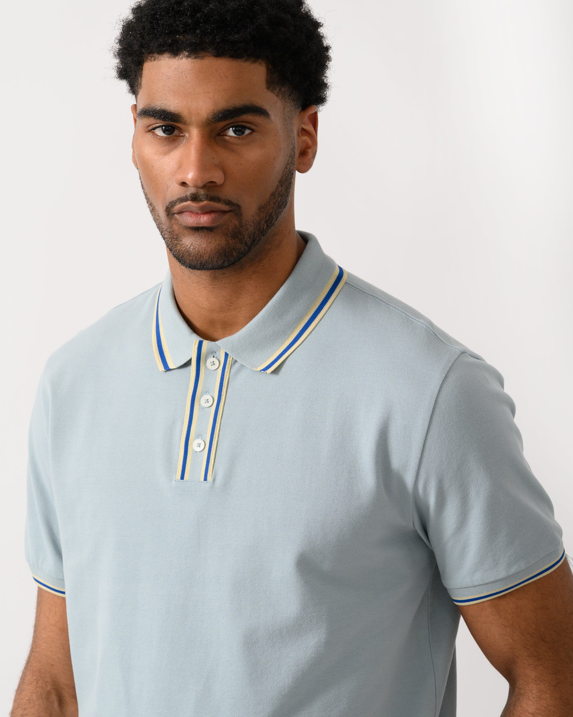 close up shot of a model wearing a PS Paul Smith Mens Regular Fit Polo Shirt in 40B Blue