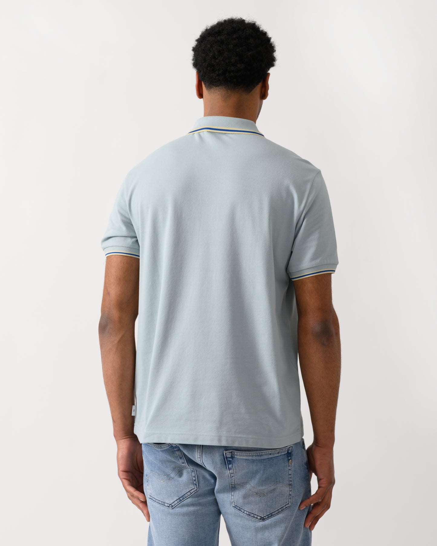 back shot of a model wearing a PS Paul Smith Mens Regular Fit Polo Shirt in 40B Blue