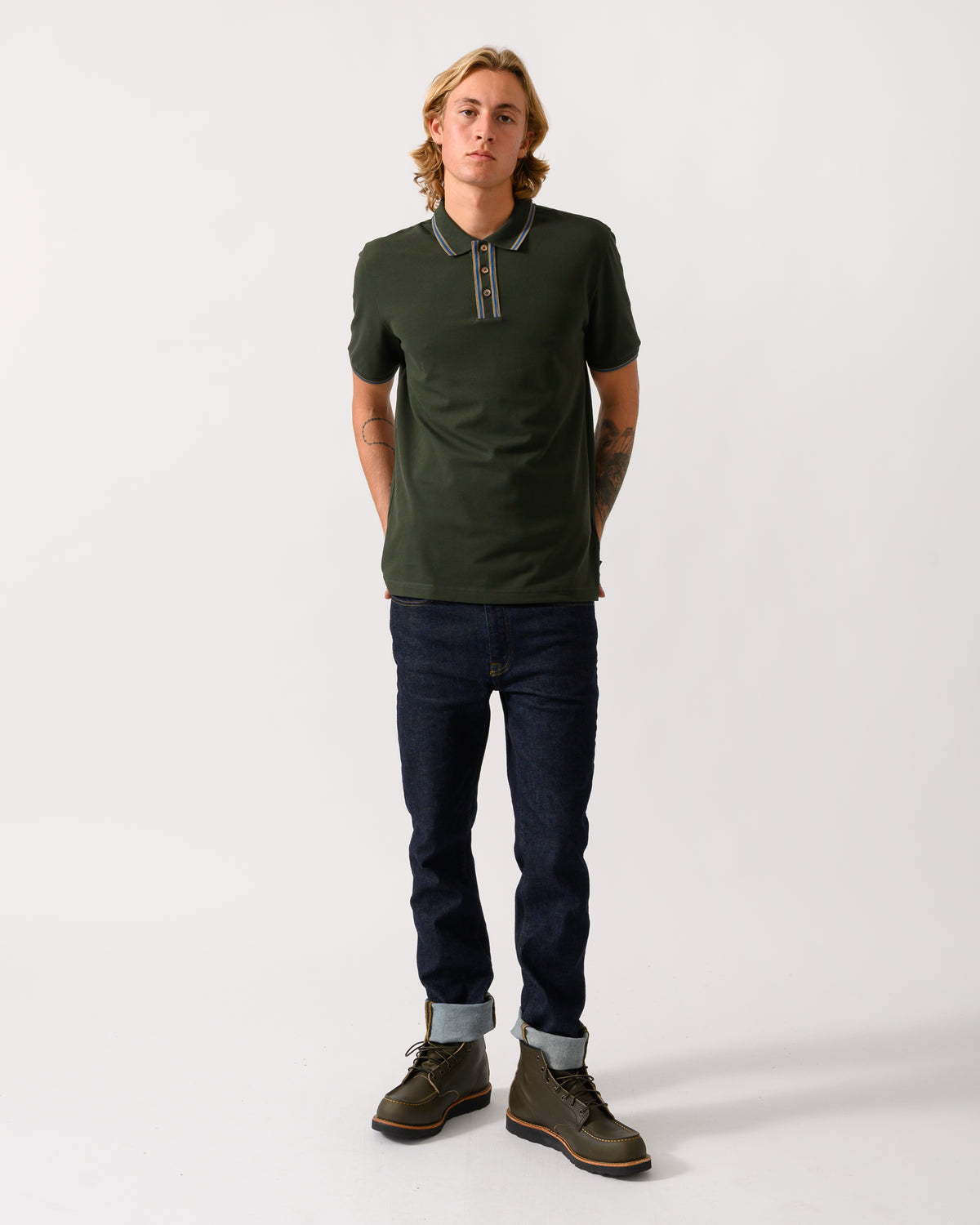 full length studio photograph of a model wearing PS Paul Smith Mens Regular Fit Polo Shirt with Tipping in 38E Bottle Green