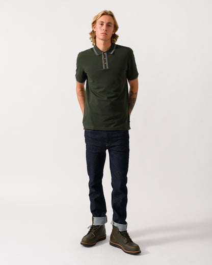 full length studio photograph of a model wearing PS Paul Smith Mens Regular Fit Polo Shirt with Tipping in 38E Bottle Green